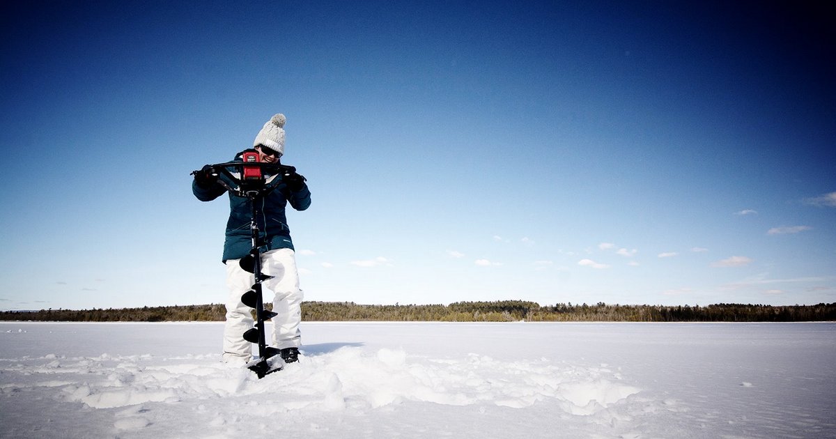 ice fishing angler drilling h hole