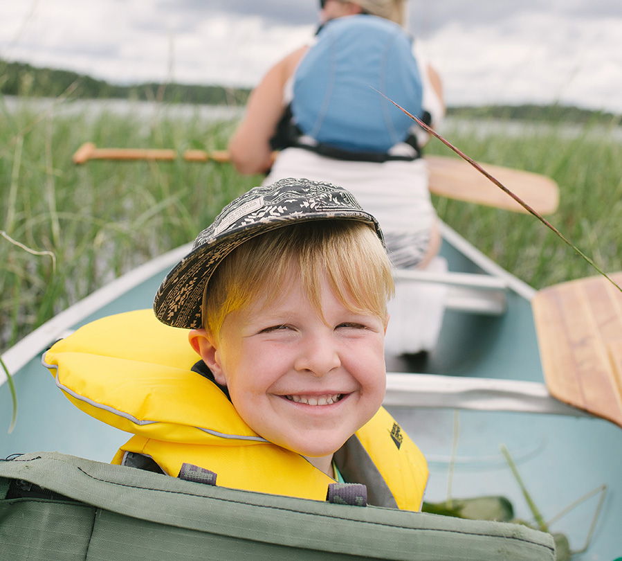 Boy smiling in canoe