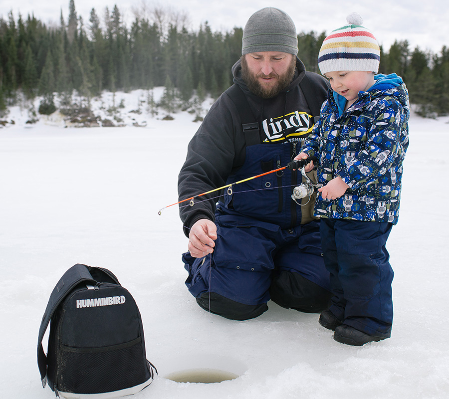 Adult with child ice fishing